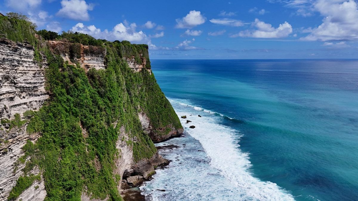 Limestone cliffs near Uluwatu above the ocean at sunset in Bali