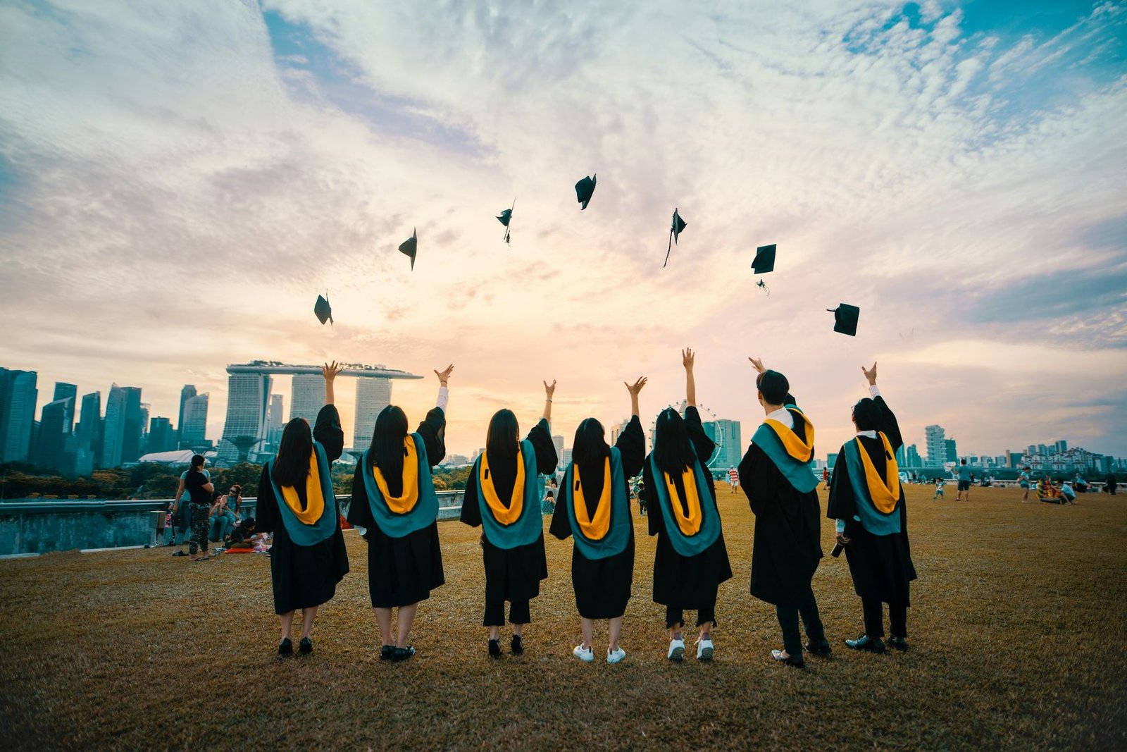 Graduates celebrating outside their university building